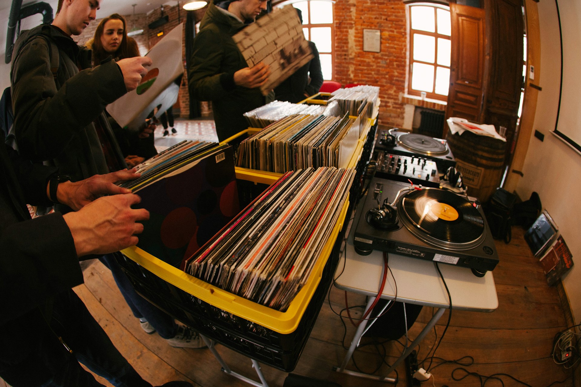 People digging through records at a DJ session