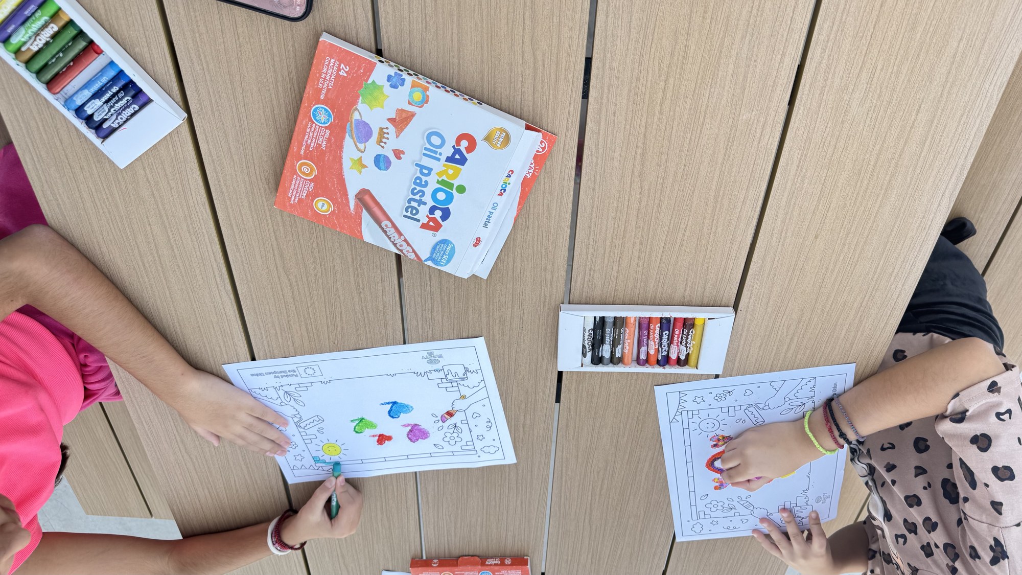 Children colouring their own versions of the wall