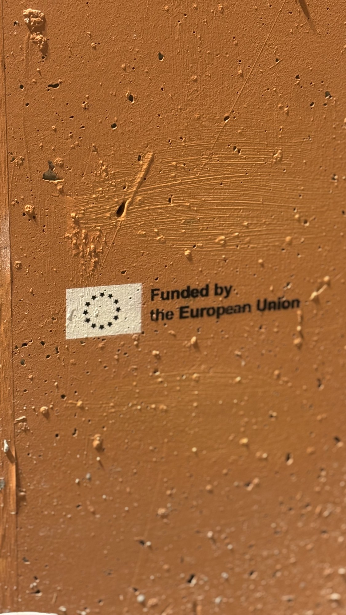 The Funded by the European Union stencil on the wall