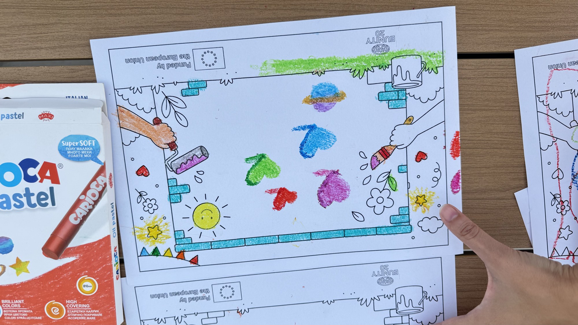 Colouring sheets and pastels on the table