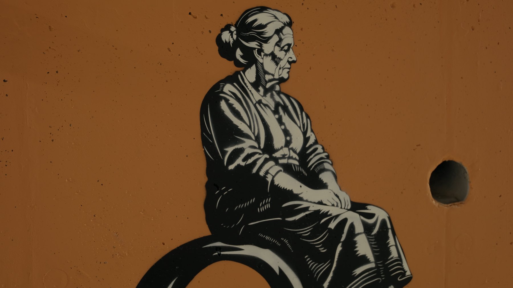 The finished mural: an elderly woman seated on an oversized key