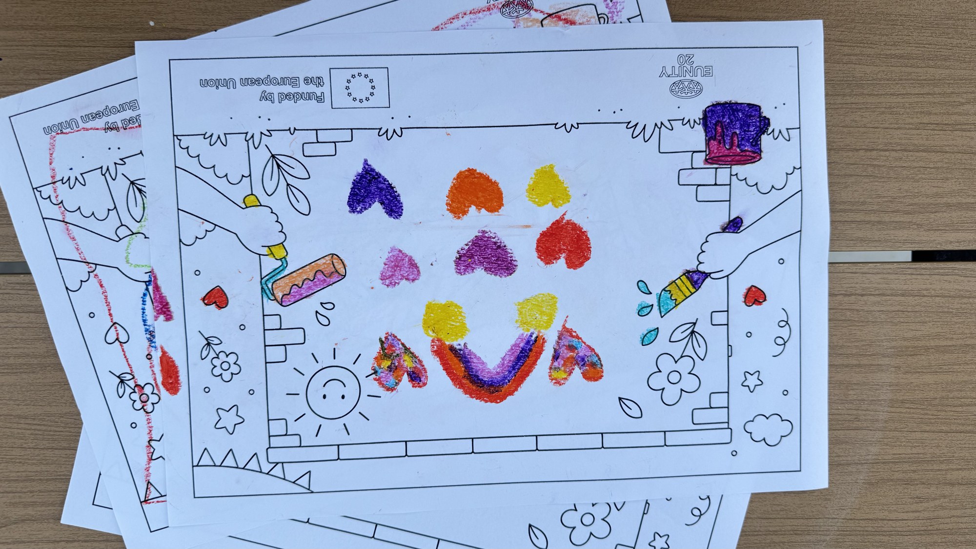 A colouring sheet of the mural, filled with hearts