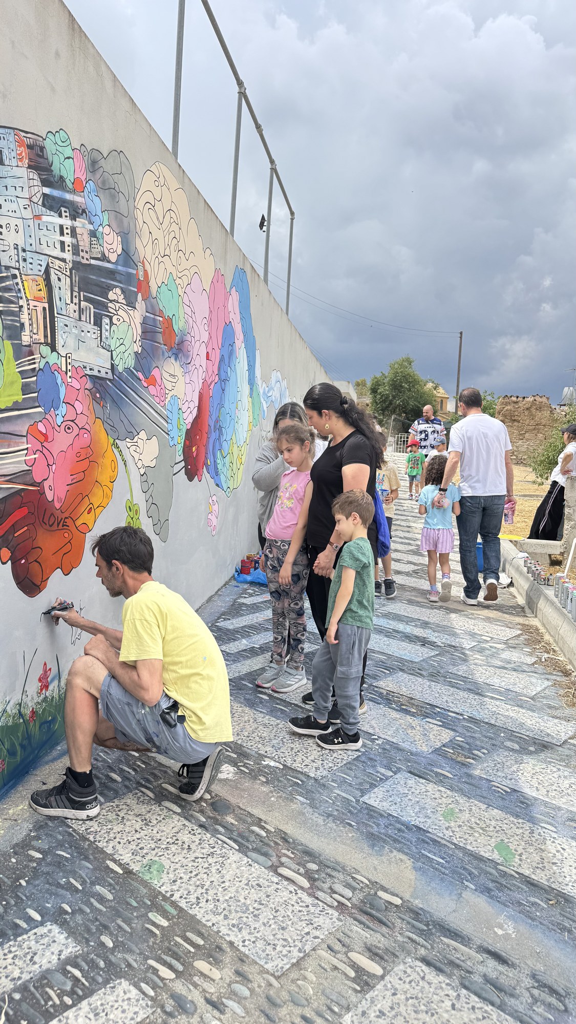 Mathieu Devavry painting alongside the community