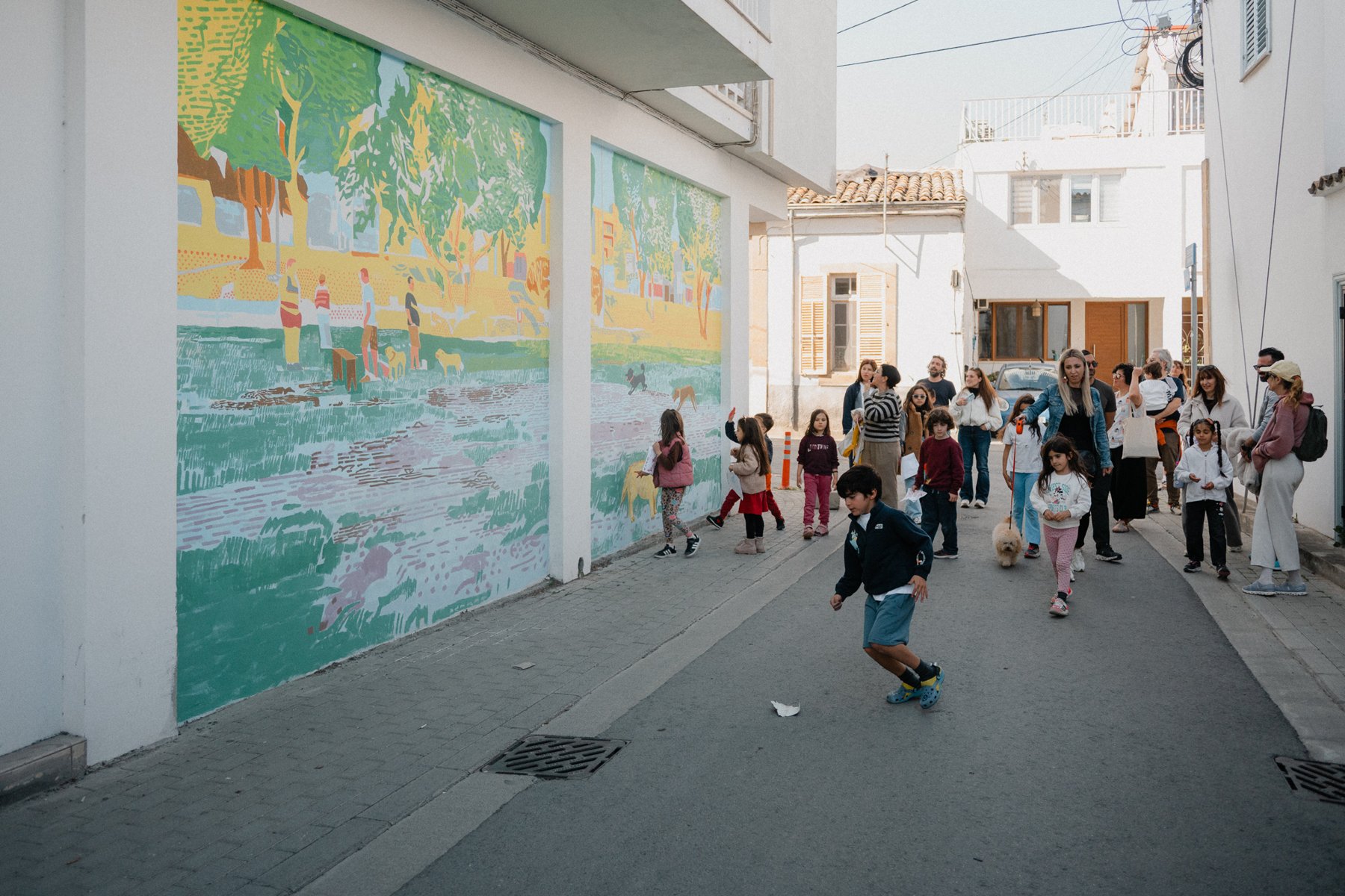 Kids on the walk past the mural