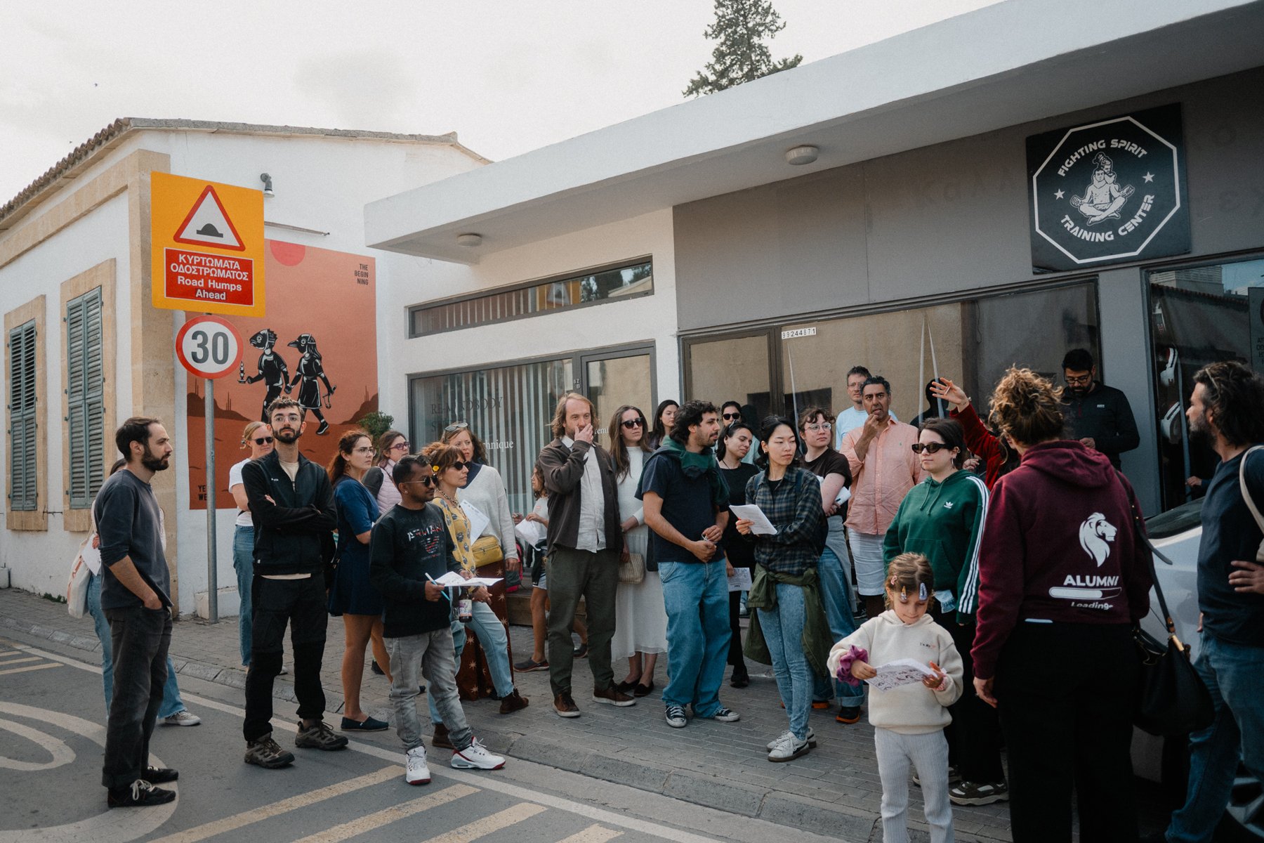 The walk gathers at the mural
